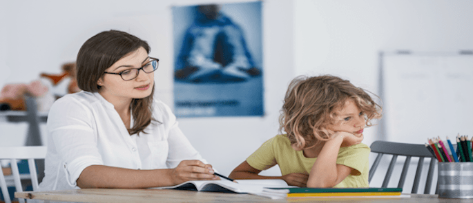 A child exhibiting signs of ADHD with a teacher